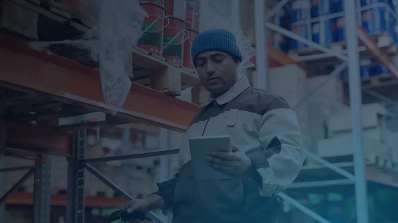Warehouse worker checking inventory on a tablet, sample photo for the Agentic ERP article